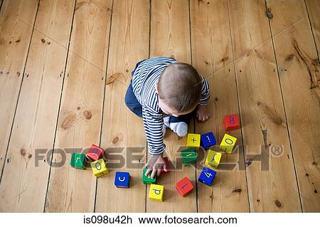 Stock Image - Baby boy playing with building blocks. Fotosearch