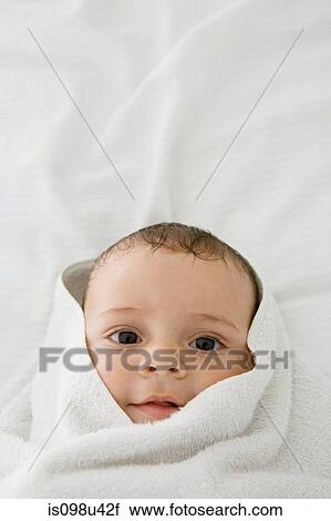 Baby boy wrapped in a towel View Large Photo Image Stock Image - Baby boy wrapped in a towel. Fotosearch