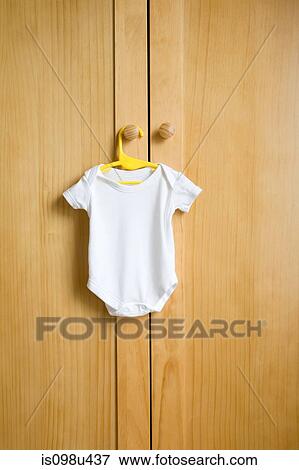 Babygro hanging on wardrobe View Large Photo Image Stock Photo - Babygro hanging on wardrobe. Fotosearch