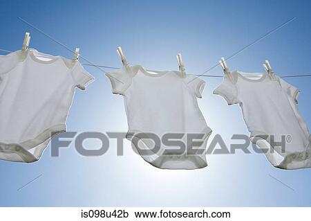 Stock Image - Babygros on a washing line. Fotosearch