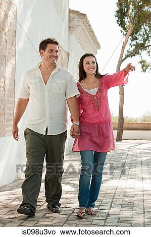 Picture - Young couple walking on holiday. Fotosearch