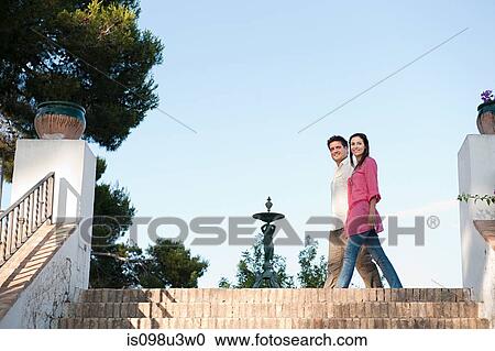 Young couple walking on holiday View Large Photo Image Stock Image - Young couple walking on holiday. Fotosearch