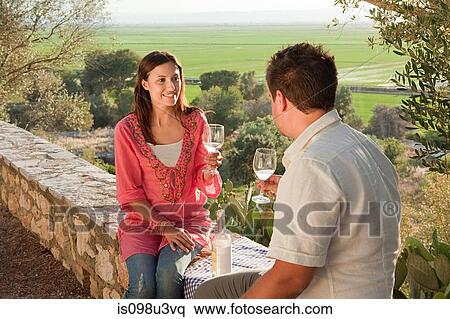 Stock Photography - Young romantic couple with wine. Fotosearch