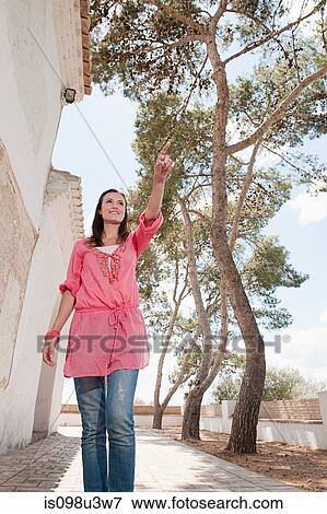 Stock Photo - Young woman walking on holiday. Fotosearch