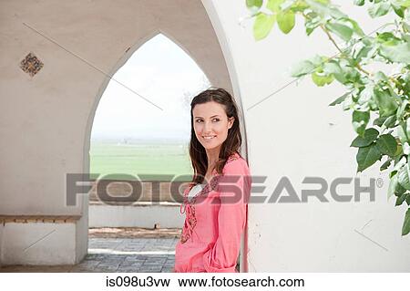 Stock Photo - Young woman with brown hair, portrait. Fotosearch