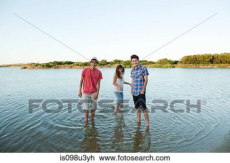 Three friends having fun in lake View Large Photo Image Stock Image - Three friends having fun in lake. Fotosearch