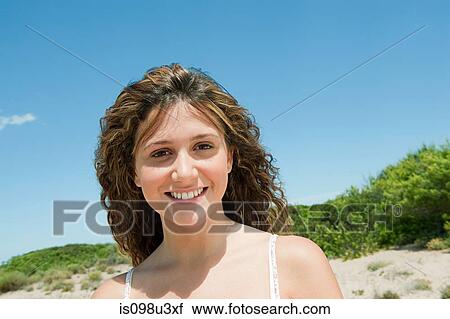 Young woman with long brown hair, portrait View Large Photo Image Stock Image - Young woman with long brown hair, portrait. Fotosearch
