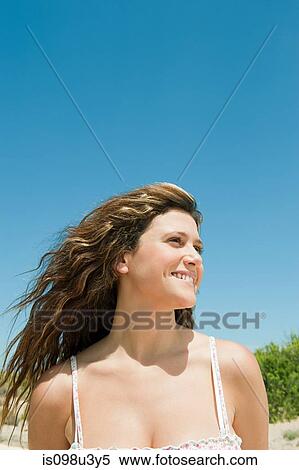 Young woman with long brown hair, portrait View Large Photo Image Stock Photography - Young woman with long brown hair, portrait. Fotosearch