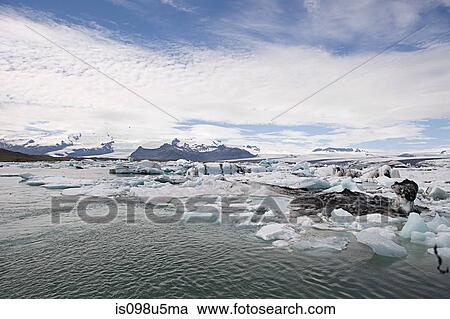 Stock Image - Iceland, icebergs in jokulsarlon lagoon drifting from vatnajokull glacier into the north atlantic ocean. Fotosearch
