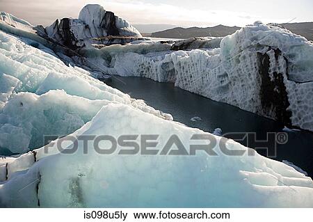 Iceland, icebergs in jokulsarlon lagoon drifting from vatnajokull glacier into the north atlantic ocean View Large Photo Image Stock Photo - Iceland, icebergs in jokulsarlon lagoon drifting from vatnajokull glacier into the north atlantic ocean. Fotosearch