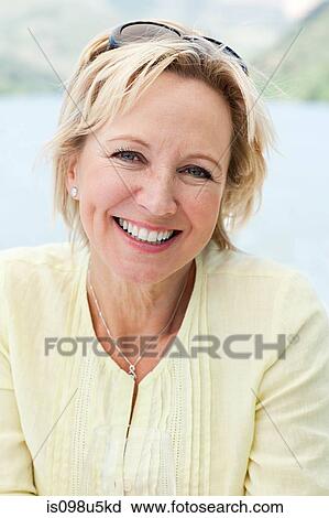 Stock Image - Mature woman on a boat holiday. Fotosearch