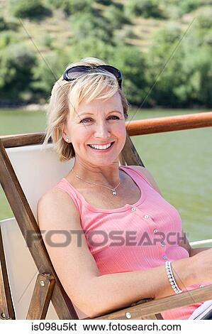 Mature woman on a boat holiday View Large Photo Image Stock Photograph - Mature woman on a boat holiday. Fotosearch