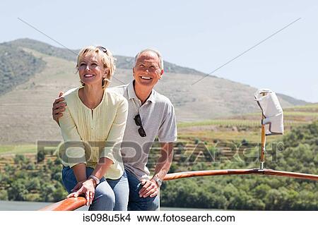 Senior couple enjoying a boat holiday View Large Photo Image Picture - Senior couple enjoying a boat holiday. Fotosearch