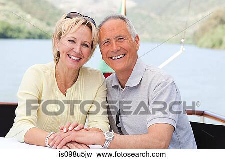 Stock Photo - Senior couple enjoying a boat holiday. Fotosearch