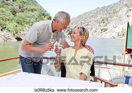Senior couple with glasses of wine on a boat holiday View Large Photo Image Stock Image - Senior couple with glasses of wine on a boat holiday. Fotosearch
