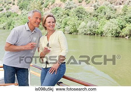 Senior couple with glasses of wine on a boat holiday View Large Photo Image Stock Image - Senior couple with glasses of wine on a boat holiday. Fotosearch