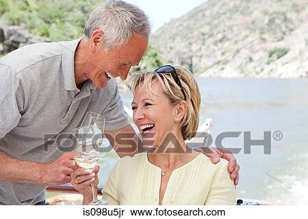 Senior couple with glasses of wine on a boat holiday View Large Photo Image Stock Photography - Senior couple with glasses of wine on a boat holiday. Fotosearch