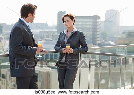 Businessman and businesswoman outside with drinks View Large Photo Image Stock Image - Businessman and businesswoman outside with drinks. Fotosearch