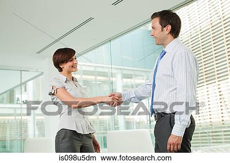Businessman and businesswoman shaking hands View Large Photo Image Picture - Businessman and businesswoman shaking hands. Fotosearch
