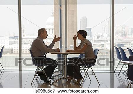 Stock Photo - Businessman and businesswoman talking. Fotosearch