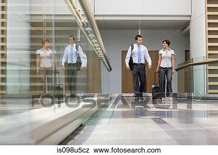 Businessman and businesswoman with suitcase View Large Photo Image Stock Photo - Businessman and businesswoman with suitcase. Fotosearch