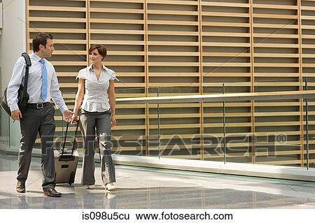 Businessman and businesswoman with suitcase View Large Photo Image Stock Photograph - Businessman and businesswoman with suitcase. Fotosearch