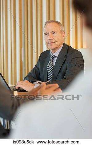 Stock Image - Businessman in meeting. Fotosearch