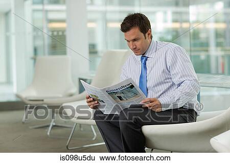 Businessman reading magazine View Large Photo Image Stock Photograph - Businessman reading magazine. Fotosearch