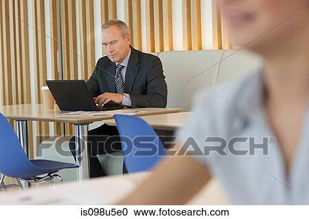 Businessman using laptop View Large Photo Image Stock Image - Businessman using laptop. Fotosearch