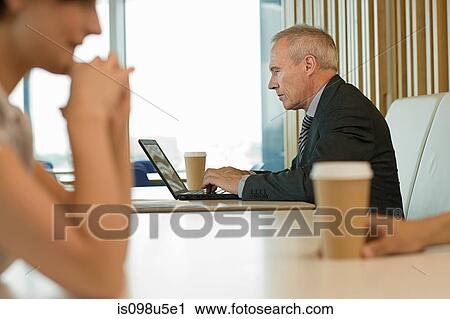 Stock Image - Businessman using laptop. Fotosearch