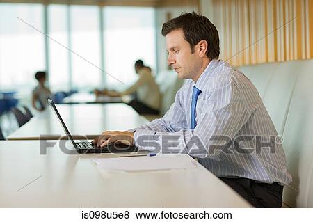 Businessman using laptop View Large Photo Image Stock Photo - Businessman using laptop. Fotosearch