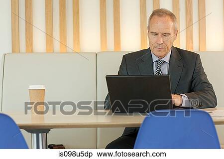 Businessman using laptop View Large Photo Image Stock Photography - Businessman using laptop. Fotosearch