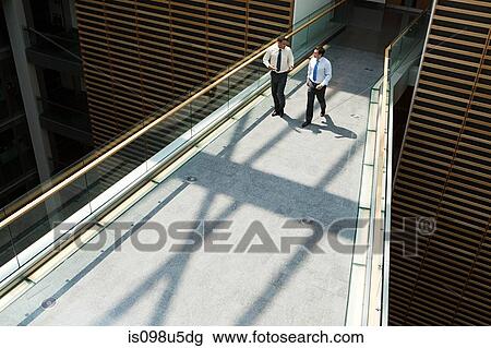 Businessmen on office walkway View Large Photo Image Stock Image - Businessmen on office walkway. Fotosearch
