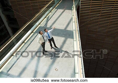 Businessmen on office walkway View Large Photo Image Stock Image - Businessmen on office walkway. Fotosearch