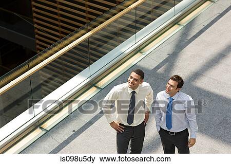 Businessmen on office walkway View Large Photo Image Stock Photo - Businessmen on office walkway. Fotosearch