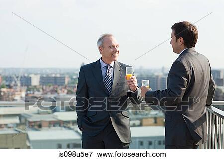 Businessmen outside with drinks View Large Photo Image Stock Photo - Businessmen outside with drinks. Fotosearch