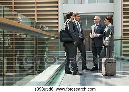 Businesspeople meeting on walkway View Large Photo Image Stock Photograph - Businesspeople meeting on walkway. Fotosearch