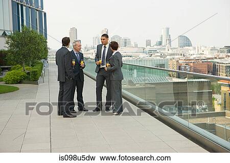 Businesspeople outdoors with drinks View Large Photo Image Stock Photo - Businesspeople outdoors with drinks. Fotosearch