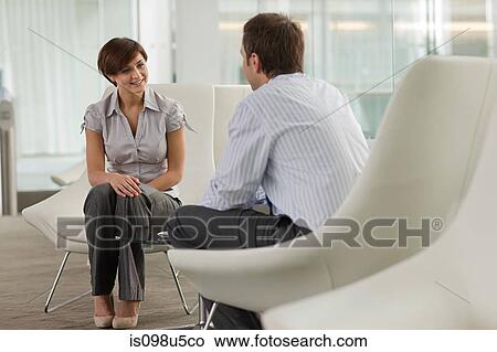Picture - Businesswoman and businessman talking. Fotosearch