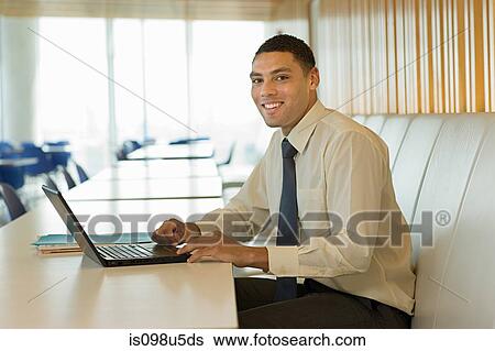 Smiling businessman with laptop View Large Photo Image Stock Photograph - Smiling businessman with laptop. Fotosearch