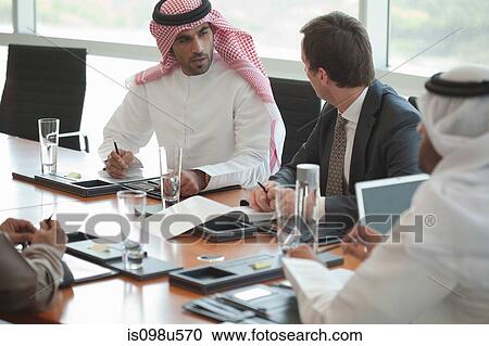 Stock Image - Businessmen in a meeting. Fotosearch