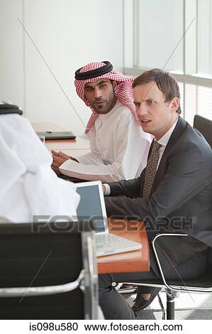 Stock Image - Businessmen in a meeting. Fotosearch