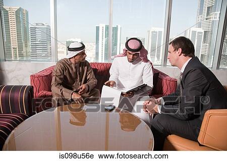 Middle eastern and western businessmen having a meeting View Large Photo Image Stock Image - Middle eastern and western businessmen having a meeting. Fotosearch