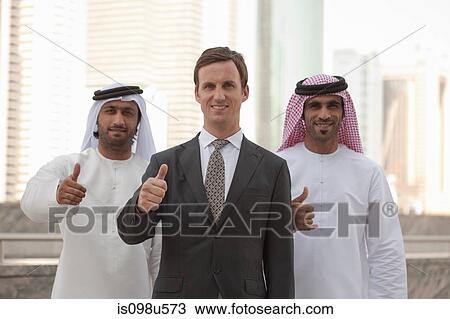 Middle eastern and western businessmen giving thumbs up View Large Photo Image Stock Image - Middle eastern and western businessmen giving thumbs up. Fotosearch