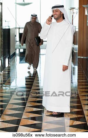 Middle eastern businessman on cellphone View Large Photo Image Stock Photo - Middle eastern businessman on cellphone. Fotosearch