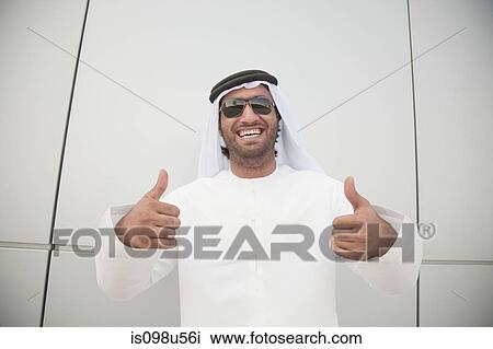 Middle eastern man giving thumbs up sign View Large Photo Image Stock Image - Middle eastern man giving thumbs up sign. Fotosearch