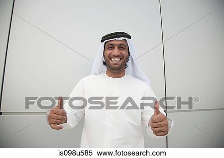 Stock Photography - Middle eastern man giving thumbs up sign. Fotosearch