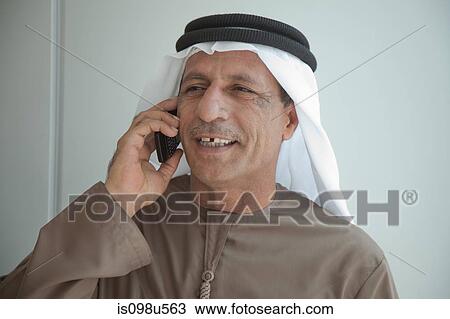 Stock Image - Middle eastern man on cellphone. Fotosearch