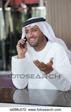 Middle eastern man on cellphone View Large Photo Image Stock Image - Middle eastern man on cellphone. Fotosearch