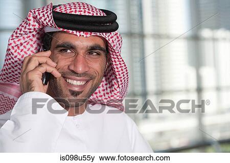 Stock Photo - Middle eastern man on cellphone. Fotosearch